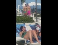 Two men in their beach wear poses beside each other