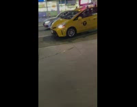 Taxi and car drive on street to evade traffic