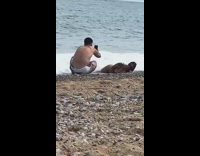 Woman bikini lie down sideways on the beach shore