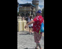 Two women in white top tiktok dance at Disneyland