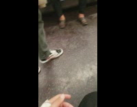 Woman has bare feet out and wiggles her toes on the subway