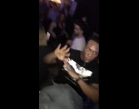 Guy in black dancing to music with whistle in mouth blowing