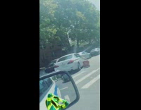 Guy in white car holds drags cooler 