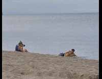 Shirtless man pants lie down beach pictorial