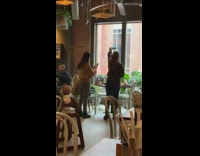 Girl phone stick takes picture above head of food