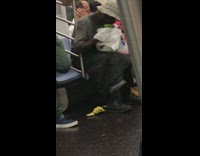 Guy eats watermelon out of bag and throws rinds skin on the ground on subway train