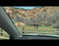 Two bald men tiktok dance near the mountains