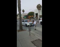 Four women dance white car street crowd cheers