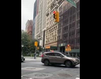 Clown standing middle of street waving