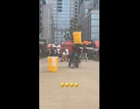 Collab winy - Man ride bike balance yellow barrel on head