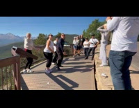 Five people dances on national park overlooking