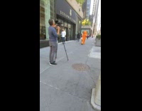 Orange lion mascot walk street hold bag