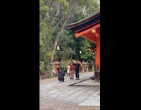 Collab IITW - Man and Woman black outfit and red dress tiktok dance near the local shrine