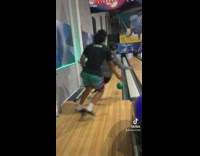 Woman plays bowling gets hit and falls 