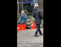 Man play trumpet stomp orange buckets