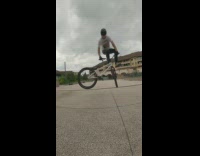 Guy does tricks on wheelie with bike 