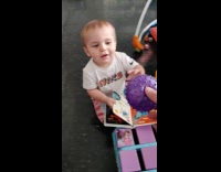 Baby grabs the ball and then tossed it behind