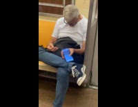 Man sleep hold phone playing video subway