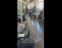 Guy sits on train floor with candle 
