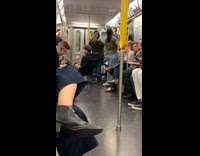 Guy sits on office chair in the middle of subway train