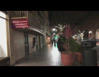 Guy black hoodie jumps up hits head on red walgreens pharmacy sign