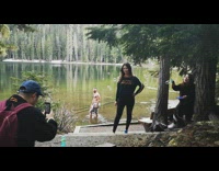 Girl bubble gun lake shirtless guy behind