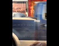 Man in devil costume dances on sidewalk