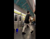 Man spins at handrail performs at subway