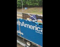 White moving truck with roof ripped off 