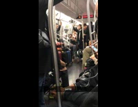 Man puts arms under legs and crawls walks down subway train aisle