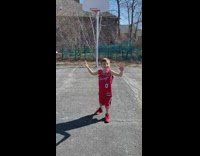 Kid hits a backwards 3 pointer shot outdoors