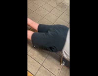 Man in gray shirt push ups on the subway station