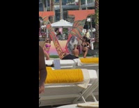Little boy takes picture of two women in bikini