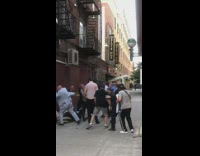 Men in suits punch each other in alley 