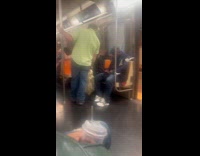 Man looking at another mans phone on subway