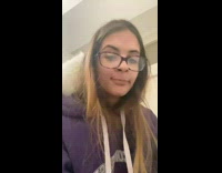 Girl walks with white cat on shoulder