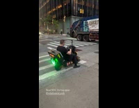 DJ rides scooter with gear mixing music