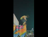 Crowd throws things at guy standing on container at festival