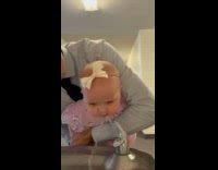 Man lets baby drink on drinking fountain