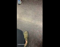 Bicycle hangs on metal bar by seat