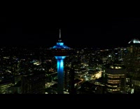 Collab PubityPets - Aerial view of the Calgary tower in color blue at night