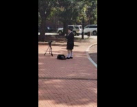 Man wears a costume and lip synced at the sidewalk