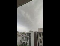 Purple and blue lightning strikes building