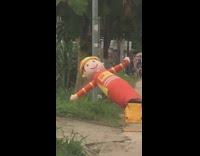 Inflatable man tipped over on back 