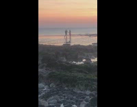 Girl dress hand on hips beach sunset