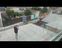 Black shirt guy sings into phone rooftop 