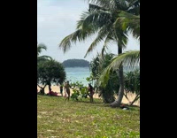 Woman hold two dragon fruit pose beach