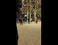 Three girls hugging trees with lights