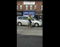 construction worker on unicycle on street