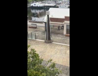 Woman gray sweater dances front of mirror wall